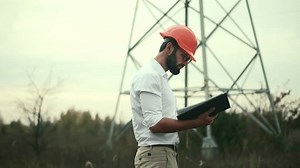 Constructor Inspect High Voltage Tower.Engineer In Hardhat Maintenance Electricity Transmission Pylon.Electrical Engineer In Helmet Power Lines.Constructor Checking High Voltage Sensor Power Line Wire