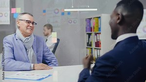 Image of two male business partners shaking hands