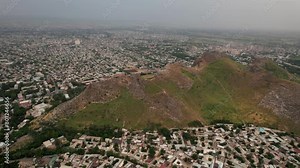 Aerial view of Sulaiman Too Sacred Mountain in Osh city, Kyrgyzstan. The symbol of the city of Osh. Beautiful powerful mountain