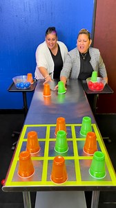 Prize game where girls slide cups for tic tac dough and mystery prizes | Doug and Friends