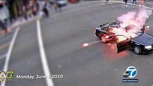 Driver lights firework during California protest, gets it tossed back into car - Video