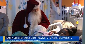Santa Claus brings early Christmas gifts to the children at St. Luke's
