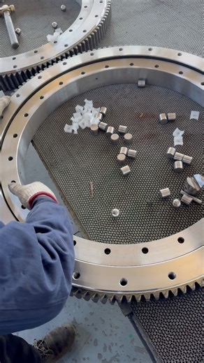 Assembly of an external gear cross-roller slewing bearing in progress. The cross-roller design provides high load capacity and rigidity within a compact structure, while precise gear and raceway alignment ensures smooth rotation and consistent performance. From component inspection to final assembly, every step is executed under strict quality control to meet demanding industrial requirements. Engineered for accuracy. Built for reliability.#SlewingBearing #CrossRollerBearing #PrecisionEngineerin