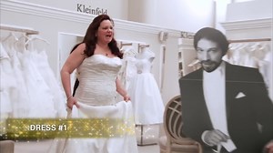 Bride Cathleen and her fiancé are both opera singers who met on stage. Wanting him to be a part of her dress appointment, she brings along a cardboard cutout of him! | Curvy Brides' Boutique - TLC