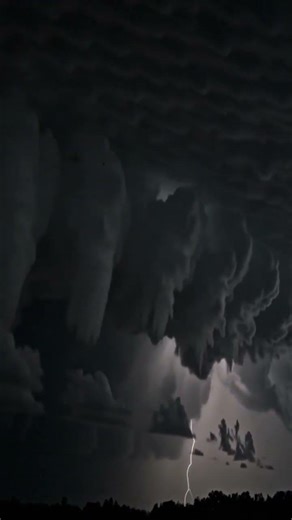 A dramatic lightning storm unfolds in a vibrant landscape, showcasing the power and beauty of nat...