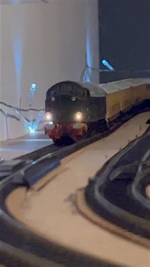 Class 40 powers through Benchester station at speed with passenger