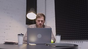 Free stock video - Serious businessman using laptop computer while sitting at table in the boardroom