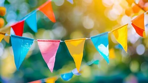 Colorful bunting flags hanging from a string in the air