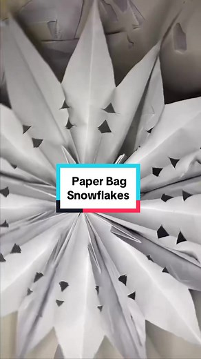 ❄️ How to make giant paper bag snowflakes! ❄️ You can use any size paper bags for these. I used puke bags I collected on airplanes, grocery bags and gift bags to make different sizes. This huge 12 ft tree needed some oversized ornaments and these were cheap and easy to make! They also make a really nice garland for stairs and mantles. #diyornaments #paperbagsnowflake #oversizedornamentdiy #holidaydecor #diychristmascrafts