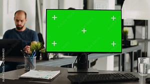 Greenscreen on computer desktop at empty workstation. PC with isolated mockup template and chromakey app running in open floor plan agency workplace, blank display copyspace technology.