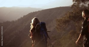 Successful hikers on mountain top looking at panoramic andscape view