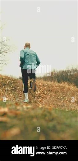Athletic runners climbing hill during trail workout. Concept of performance footwear promotion, off-road running gear marketing, endurance training visuals, outdoor sport branding Stock Video Footage - Alamy