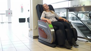 Woman relaxing in massage chair