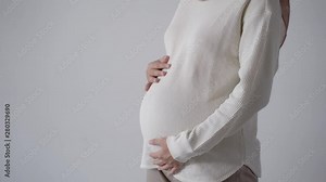 beautiful asian woman pregnant wearing hijab standing on white background