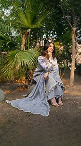 Mahnur | Angan AG 008 Ethereal Grey Sophistication. An exquisite choice in a soft light grey hue, this outfit showcases exceptional craftsmanship. The elaborate embroidery features stunning vertical panels and wave patterns in soft gold and blue #Mahnur #Angan #Lawn2026 | Mahnur
