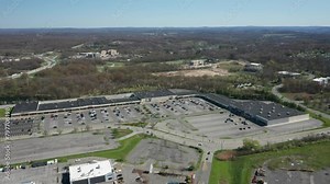 4K Aerial Drone footage of industrial shopping centers and strip malls in Middletown New York (Hudson valley). Highways (17) and traffics can be seen with mountains in the background. Clip 21 of 22