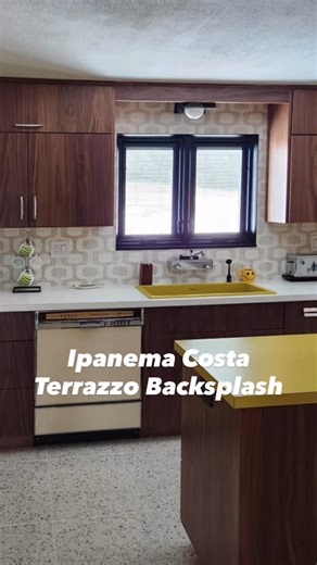 Tesselle on Instagram: "Doug’s mid-century modern kitchen remodel in Finleyville, Pennsylvania is full of heart, history, and amazing design. The Tesselle Ipanema Costa Terrazzo Tile backsplash sets the tone, bold yellow accents add personality, dark cabinetry creates drama, and large format terrazzo flooring completes the look. Best of all, original details were preserved to keep the soul of the home alive. ✨ #MidCenturyModern #KitchenRemodel #TerrazzoTile #Ipanema #InteriorDesign"