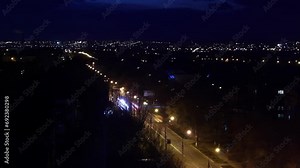 Nighttime cityscape timelapse shows urban lights flickering, streets bustling with vehicles, life in fast-forward. Dynamic city life captured from elevated view as dusk turns to dark.