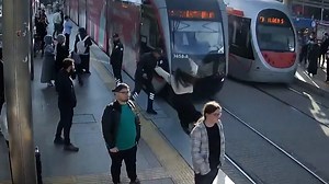 Horrifying moment: A woman was rescued by a security guard after she stepped in the path of an oncoming tram in Turkey. | Daytona Beach News-Journal