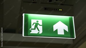 Emergency fire exit sign in doorway office building with siren alarm sound for evacuation people, escape plan guidance