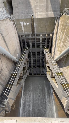 Water management with dam spillway gate by releasing the extra water
