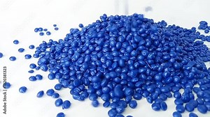 blue masterbatch granules fall like raindrops from above, forming mounds and layers of masterbatch, isolated on white background, for plastic industry product profile video