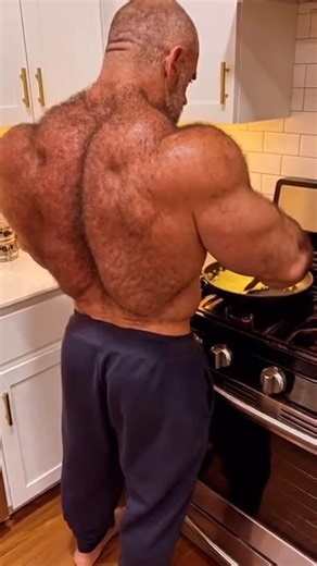@alphamales.ai on Instagram: "🍳 DINNER WITH AUTHORITY: WHEN DADDY DEMANDS MORE THAN EGGS 🍳 That moment when daddies raw power turns from the stove to demand accountability. First, you’re mesmerized by that impenetrable armor of muscle—his back carved from decades of iron discipline, covered in masculine fur that doesn’t apologize for its dominance. Then comes THE TURN. „You get these homework pages done yet? Or am I gonna stand here all night asking?“ That voice. That look. Those