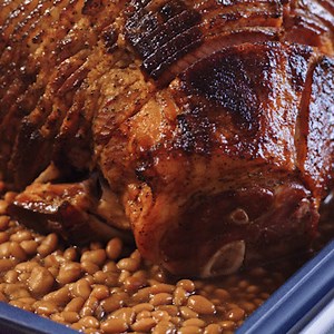 #ad A glazed ham baked on a bed of @bushbeans? Now that's a dish worthy of any holiday get together. | Allrecipes