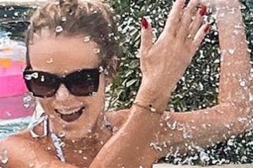 Amanda Holden splashes lookalike daughter, 15, in the pool on family holiday