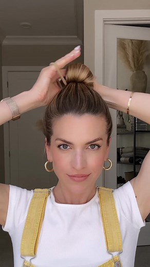 This high bun is easy to achieve, only requires one elastic, and resembles one of my favorite tasty treats: the croissant 🥐 Plus, it’s not going anywhere until you take it out! Gather hair into a high ponytail and flip it upside down. Place a hair tie around the base to create a mini bun. Twist one time. Flip the top of your ponytail over the mini bun and wrap the hair tie over it. Tuck any loose ends inside the croissant and secure with a bobby pin, if needed. 🤍 #hair #hairtutorial #hairtok