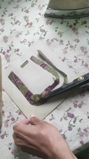 Shaping the fabric with a hot iron during the process of making a cloth coaster so it forms neatly.