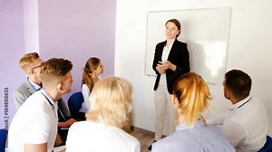 Female speaker giving presentation for students in lecture hall
