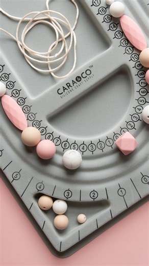 Our bead board trays are total lifesavers when it comes to wristlets, bracelets, honestly, any design! 🙌 Lay out your beads, measure your cord, play with different combos, and then string it all together with ease! ✨Find them (and all your silicone bead crafting items!) on our website - tap the link in our bio to shop! ~ ~ #createdwithcarasupply #carasupply #beadsfordays #beadsupplies #beadsaccessory #siliconebeads #siliconebeadsnorthamerica #siliconebeadsupplies #diysupply #sensorytoys #diypro