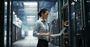 clip-3798661197-focused-female-data-center-specialist-using-laptop