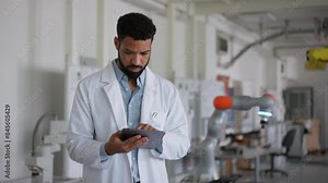 Robotic engineer calibrating or adjusting robotic arm, controlling its actions. Concept of robotics, engineering and computer science.
