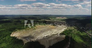Industrial of opencast mining quarry with lots of machinery at work / quarry green in Ural Mountains. Extraction of iron, copper, gypsum, calx, magnesite. Aerial drone wide view at summer sunny day