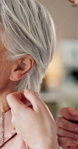 Healthcare, hands of doctor and patient ear in hospital for check up, diagnosis or hearing loss exam. Closeup, elderly woman or audiologist in practice with otoscope, tinnitus symptoms or appointment