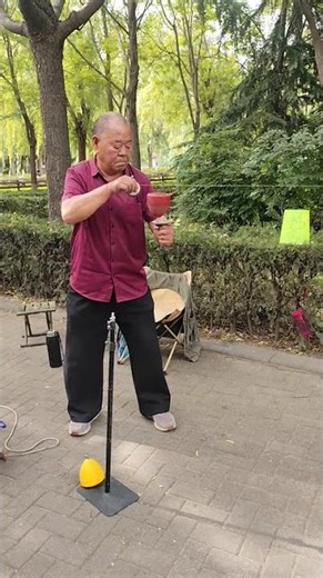 Elderly man performs diabolo trick with spinning top in Henan, China