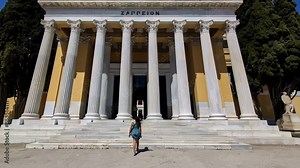 Slow motion follow shot of female tourist entering Zappeion Hall in Greece