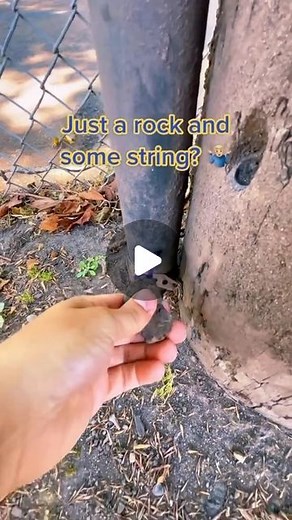 Geocaching on Instagram: "💡 Pull the lever, Kronk! 💡 How did you start geocaching? Video by hullsome_geocaching. Video: A geocacher stands next to a telephone pole and a chain link fence. Attached to the telephone pole is a PVC pipe. At the bottom of the pipe is a small rock attached to a string. They pull on the rock, and then the camera jumps to look down the pipe. Inside, a cylinder cache container rises towards the camera. The camera angle changes, and the cache container emerges from the