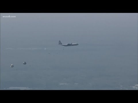 WATCH: Dozens of paratroopers jump out of a plane at paratrooper convention