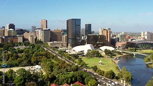 Torrens river waterfront of Adelaide city in South Australia – aerial cityscape as 4k.