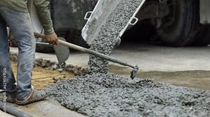 Cement mixer truck delivering concrete to construction site. Concrete mixer delivers concrete, truck moving on city road. Mixer truck transporting cement.
