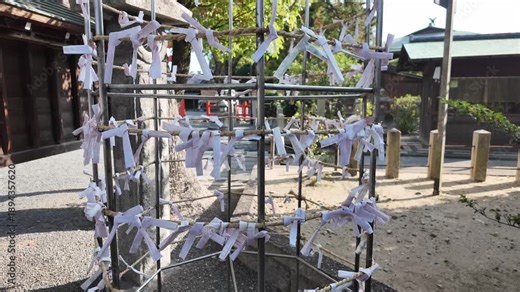Shinto Prayer Paper Strips on Fence at Japanese Shrine