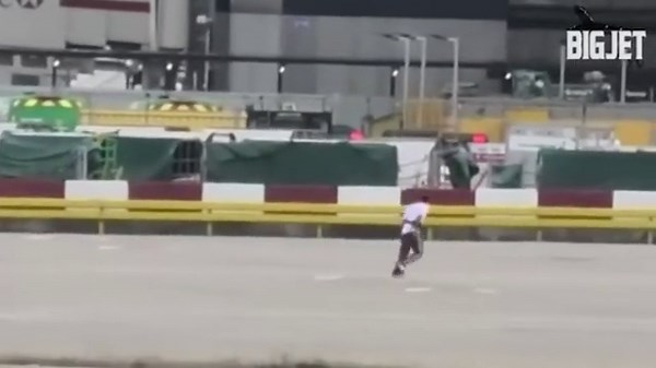 Moment man chased across Heathrow Airport tarmac as he runs around moving planes