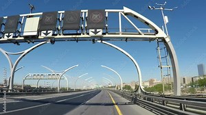 View from the moving car on the modern speedway with portly signs and signs with names of streets in Russian