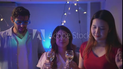 Group of friends partying in their home and moving to the music, having fun together, Enjoying drinking alcohol in celebration