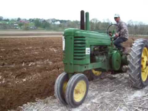 Tractors Plowing Field