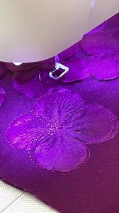 Create stunning 3D floral embellishments! Use a Darning/Embroidery Foot; disengage feed teeth. Set machine for a straight stitch. Stabilizer on the bottom, then main fabric; add silk flower petals arranged as desired, then tulle on top. Free-motion stitch to secure layers together. #singersewingmachine #itstartswithastitch #tipsandtricks | Singer North America