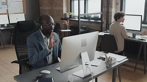 Professional Man On Video Call In Modern Office
